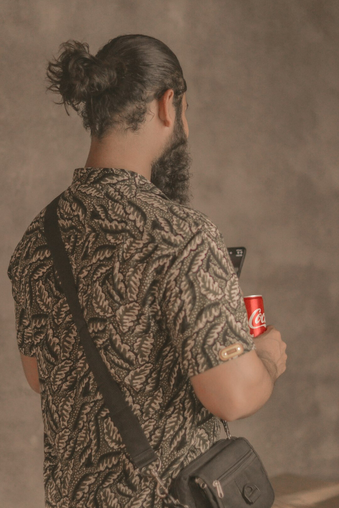 Portrait of a man with a beard and a camera strap
