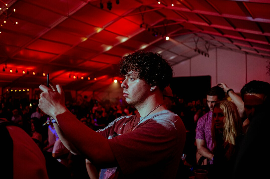 Photographers with camera flashes at an evening red carpet event