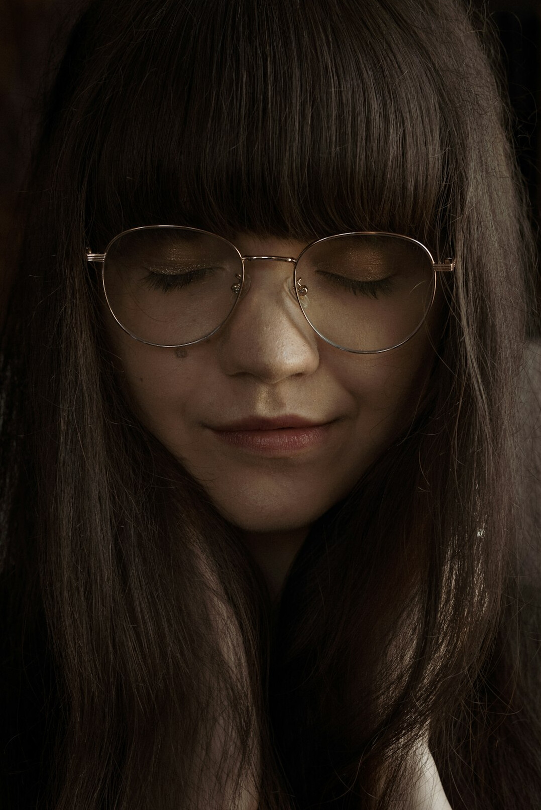 Portrait of a woman with straight brown hair and glasses